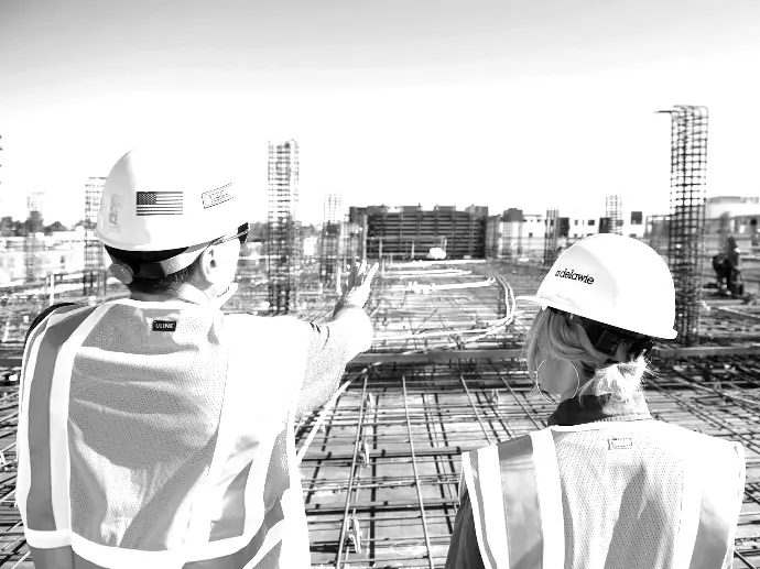 man in white hard hat standing on brown wooden dock during daytime